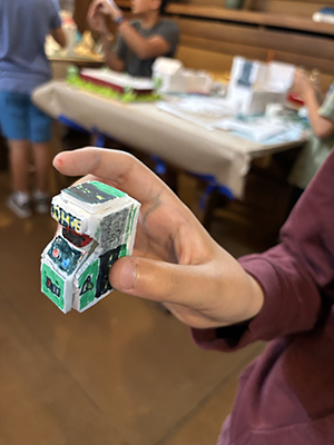 A camper shows off one of the details from his model. He turned the floorplan into an arcade and created a small arcade machine to go inside.