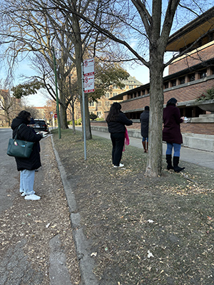 Educators stand in rows to capture each angle of Robie House from different views.