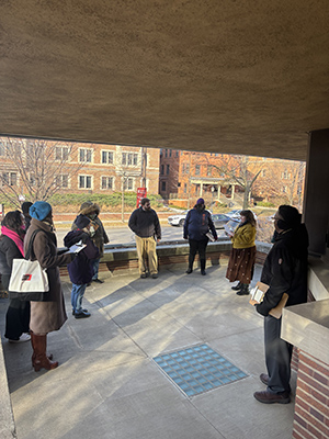 On the front porch of Robie House, participants get ready to write a poem about their experience at the house.