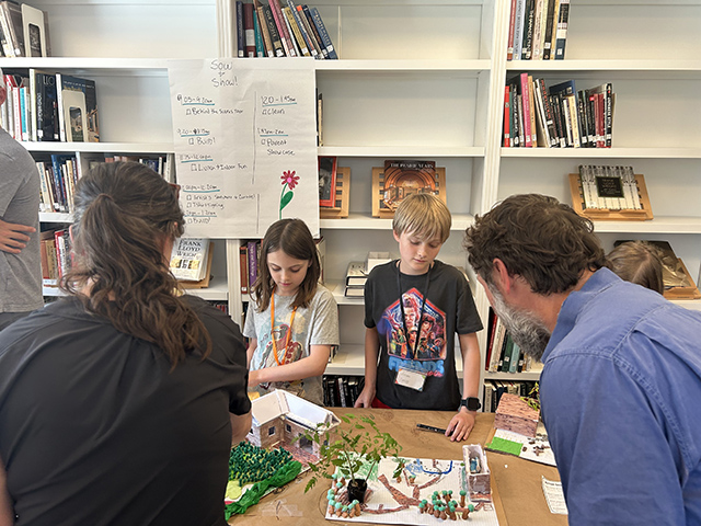 Campers present their models to friends and family on the final day of camp.
